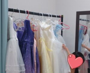 キッズUSランド大阪今福鶴見店のセルフ写真館にて、変身する衣装のドレスを探す娘